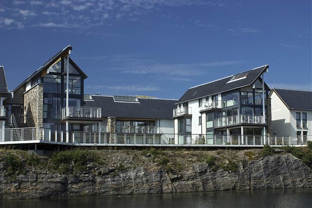 View of courtyard letting apartments from pontoons with boardwalk in foreground. View of courtyard letting apartments from pontoons with boardwalk in foreground.
