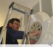 The clock being replaced in the entrance screen