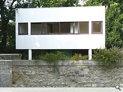 A trademark white box sits on "pilotis" with a panoramic window